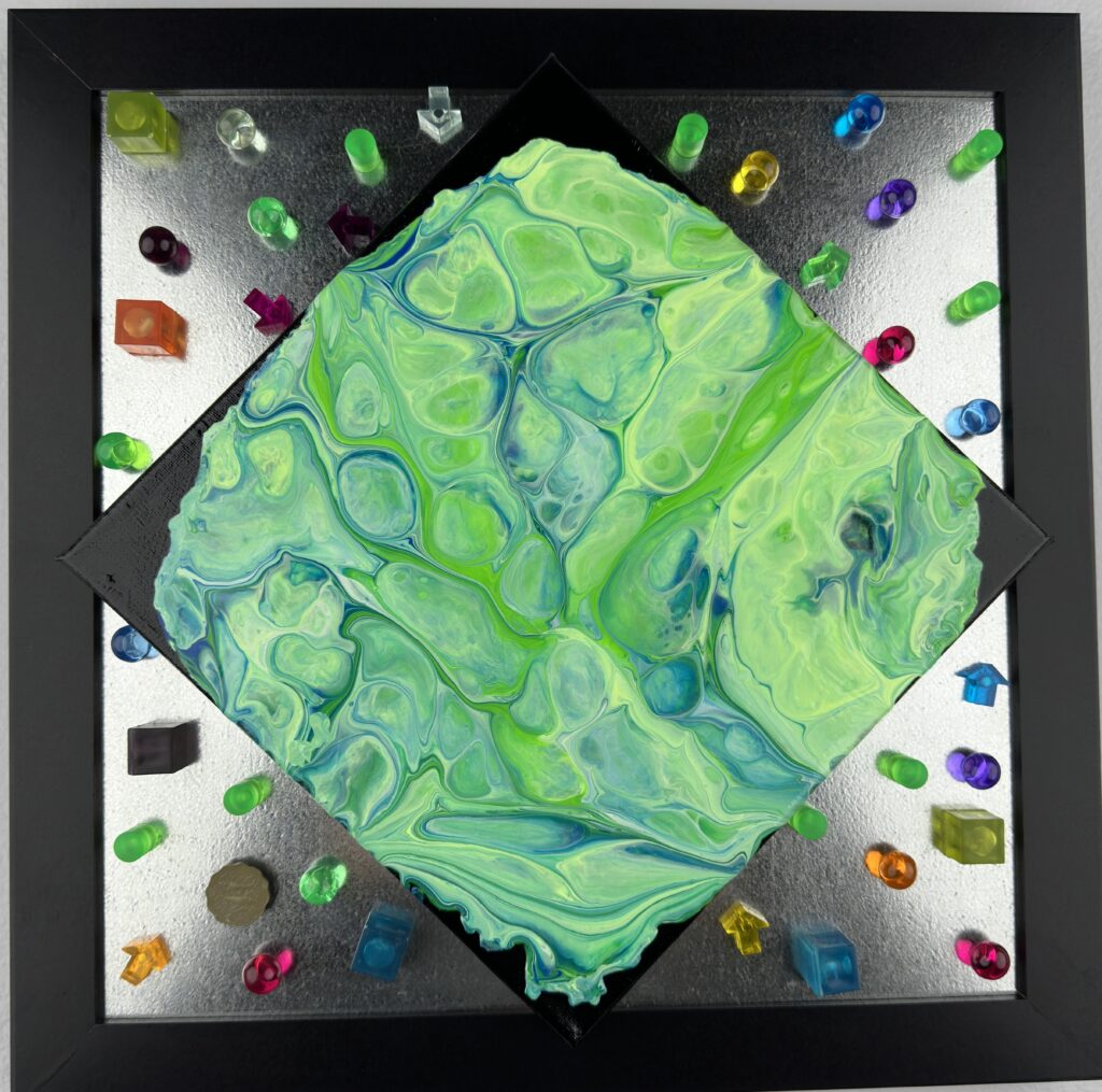 A green and blue painting with some colorful rocks around it