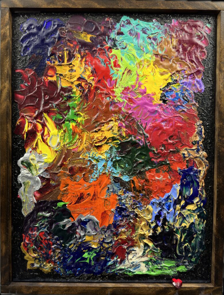 A painting of many different colors on top of a wooden frame.